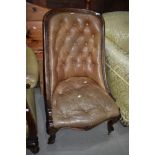 A 19th Century beige leather button back nursing chair on mahogany scroll frame`