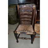 A traditional rush seated ladder back chair