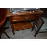 A Victorian mahogany side table/wash stand having frieze drawer on turned frame, with glass top