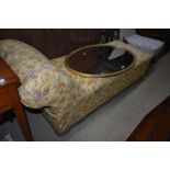 A traditional chaise longue having vintage yellow paisley cotton cover