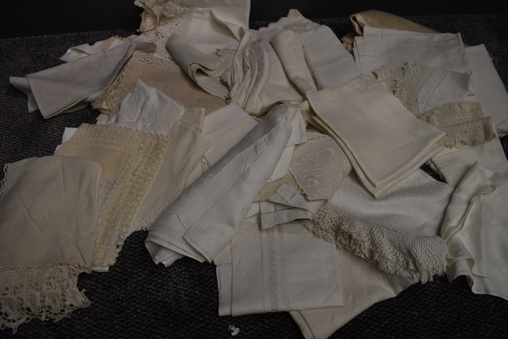 A collection of white work table linen, with various techniques and fabrics used.