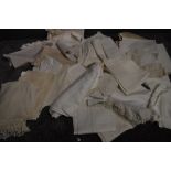 A collection of white work table linen, with various techniques and fabrics used.