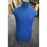 A vintage French male mannequin torso in blue 'Cleo 77 Changis sur Marne' printed to front.