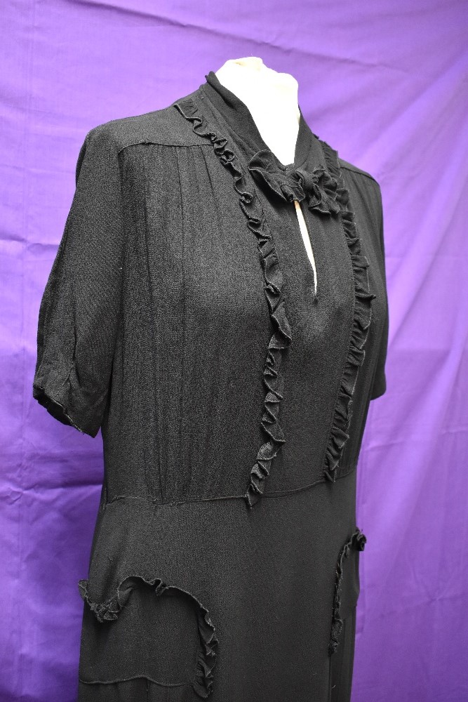 A 1940s black crepe dress with frilled details,bow to neckline and tucks to skirt, around a medium - Image 2 of 5
