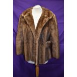 A 1960s short honey blonde mink jacket, with half belts to sides and wide collar.