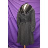 A ladies early 1950s fit and flare coat in grey wool with astrakhan collar,faux double breasted