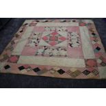 A large Victorian patchwork quilt, using various wool and wool blend fabrics, around a double in