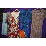 Six brightly patterned vintage 1980s dresses, mixed styles and sizes.