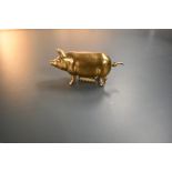 A delightful antique novelty retracting tape measure in the form of a little brass pig, twizzle