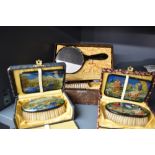 Two pretty vintage brush and mirror sets in boxes having Dutch scenes or similar, with transfers