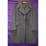 A blue 1953 dated great coat with Gieves of london label.