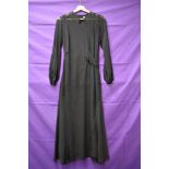 A vintage 1930s sheer black over dress having balloon sleeves with ladder work detailing towards the