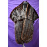 A dark brown mink stole having capstick and Hamer,Bradford and Morecambe label.