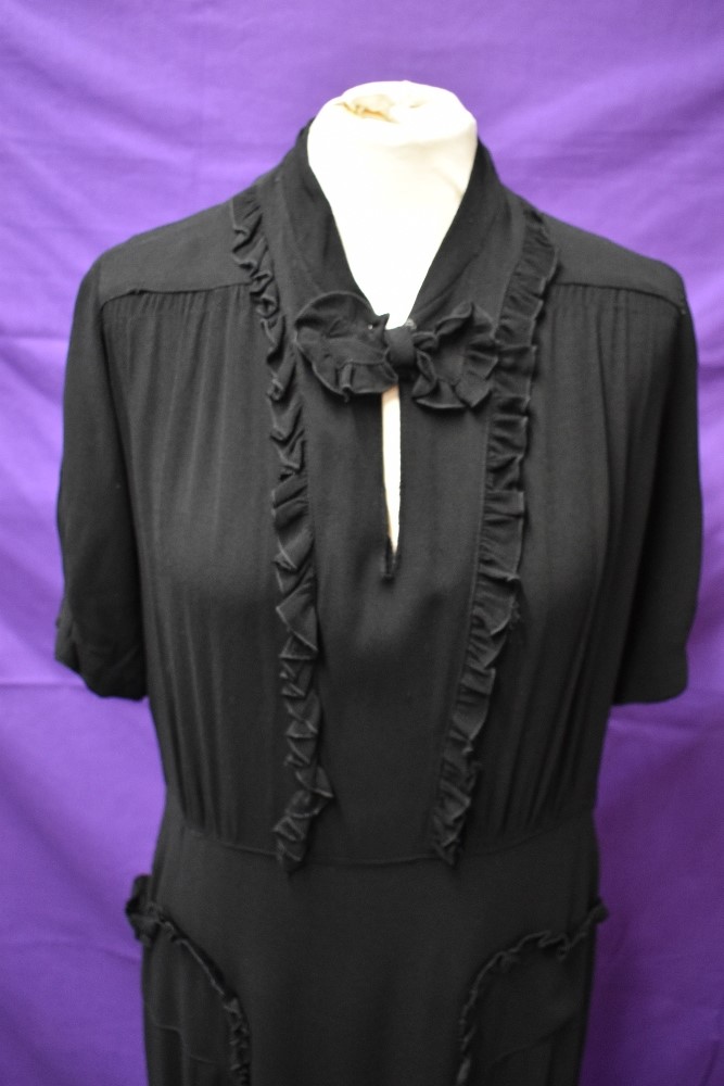 A 1940s black crepe dress with frilled details,bow to neckline and tucks to skirt, around a medium - Image 3 of 5