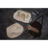 Three extensively beaded antique bags and a coin purse.