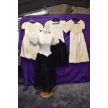 Four vintage dresses, including two 1980s black and white lace Catchet by Bari Protas dresses.