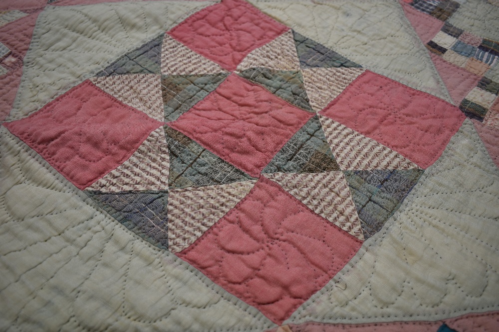 A large Victorian patchwork quilt, using various wool and wool blend fabrics, around a double in - Image 3 of 5