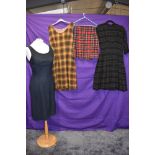 A collection of vintage clothing including 1950s wool dress, two late 50s/60s pinafores and a tartan