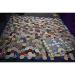 Two retro patchwork quilts, having vibrant floral fabrics used throughout.