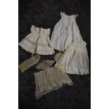 A selection of antique childrens items including a fine tulle lace apron and similar items,and