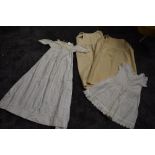 A small lot of early 20th century items,Two childrens wool petticoats or undergarments,a dress