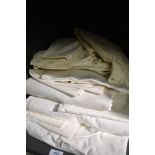 A good quantity of vintage bed linen and huckaback towels,including embroidered pillow cases and