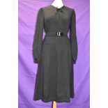 A 1930s/early 40s black textured crepe dress with belt to waist,bow to neckline and balloon