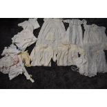 A varied lot of childrens/babies clothing, some knitted, others cotton with delicate detailing,