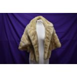 A blonde mink shrug with sleeves/jacket having F.M.R monogram to lining.