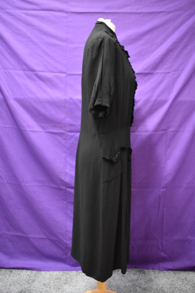 A 1940s black crepe dress with frilled details,bow to neckline and tucks to skirt, around a medium - Image 4 of 5