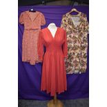 Three 1940s and 50s dresses including cherry red wool dress with honeycomb smocking.