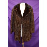 A late 1960s/70s Karakul lamb coat, with wide mink collar.