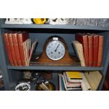 An oak cased mantle clock of Napoleon design and Book of knowledge and printing text books