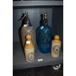 Two local Morecambe interest bottles and similar Soda Syphons one wire wrapped and similar Aqua Blue