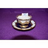 An antique tea cup and saucer set by Meissen having gold and cobalt decoration over white ground