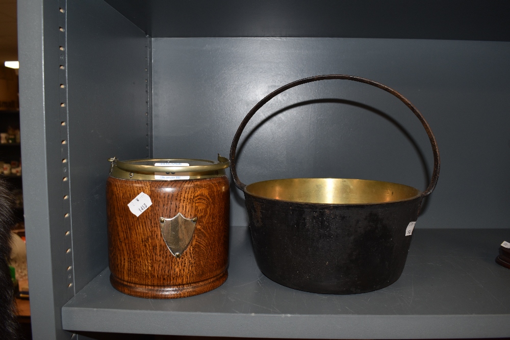 An oak biscuit barrel and brass jam pan