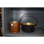 An oak biscuit barrel and brass jam pan