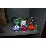 A selection of paper weights and glass dumps including lustre colour art and figural
