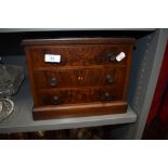 A miniature apprentice cabinet makers example of a chest of three drawers having flame mahogany