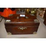 A mahogany case tea caddy having brass edge work and banding with compartmental inner tins