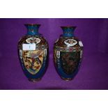 A pair of cloisonné vases depicting mythological beasts, flowers and more.