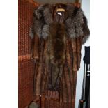 A brown mink coat a fox fur stole and a taxidermy fox wrap with head and feet