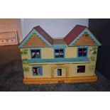 A GB Toys wooden two storey Dolls House named The Beeches, having tin plate windows with a selection