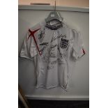 A 2005-2007 England Football Shirt, size mens small, bearing approx 10 signatures including Wayne