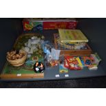 A shelf of vintage toys and games including French Jeu De L'oie folding board game, Scrabble