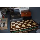 Three modern Chess sets, one in a Jaques box, a selection of Chess related video cassettes and a