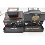 Two Polaroid cameras. An SX-70 Land Camera Palasonic Auto focus and a Model 2