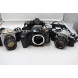 Four cameras, a Pentax S3 with Auto/Takumar 55mm lens, a Pentax Z-20 body, a Pentax ME Super, and