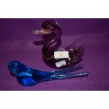 A blue glass swallow and a amethyst tinted swan.