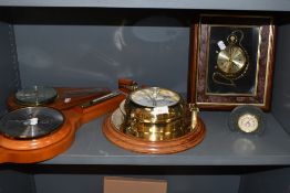 A selection of barometers and wall clock having brass porthole design